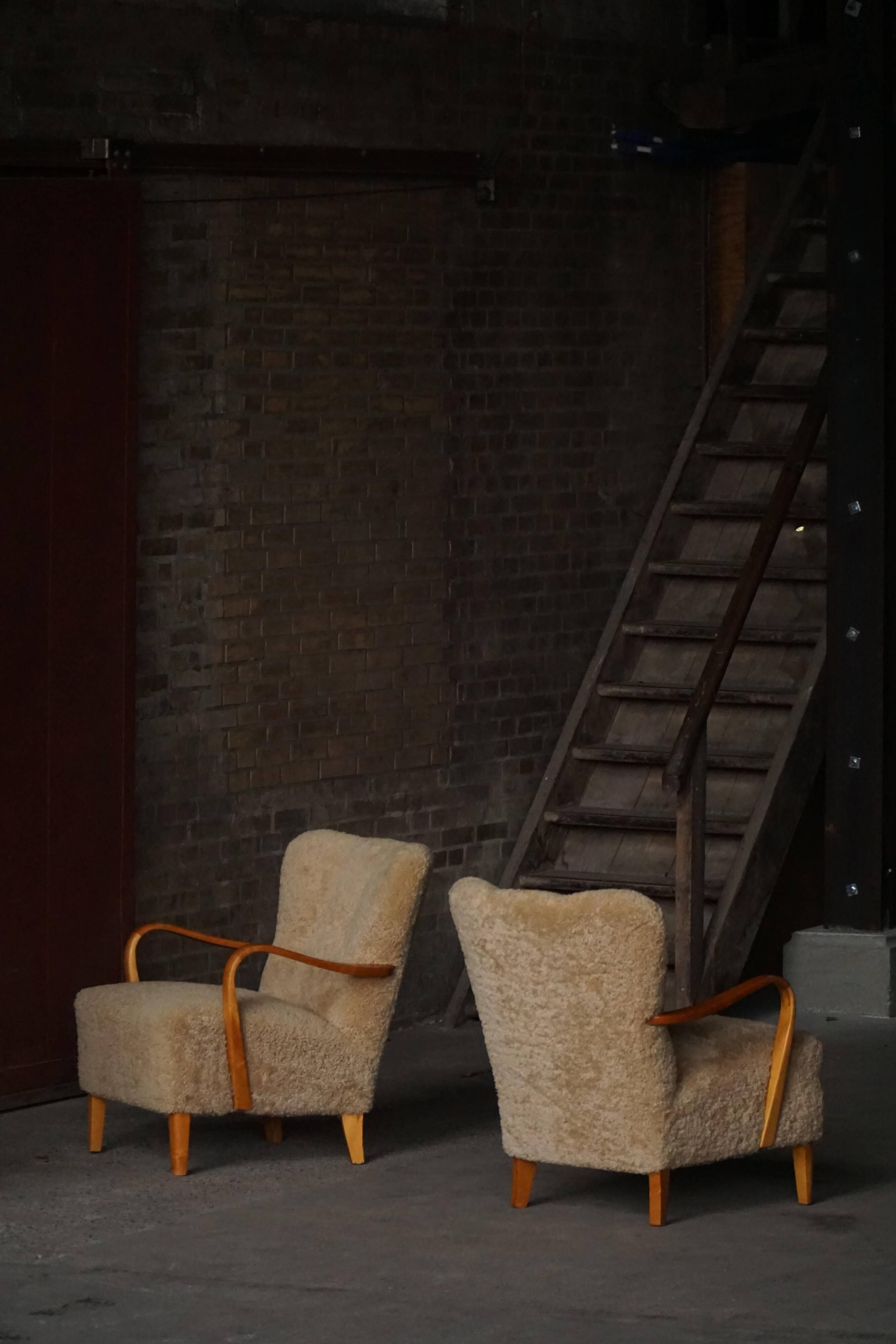 Pair of Mid Century Modern Swedish lounge chairs in birch and lamb's wool, 1960s.