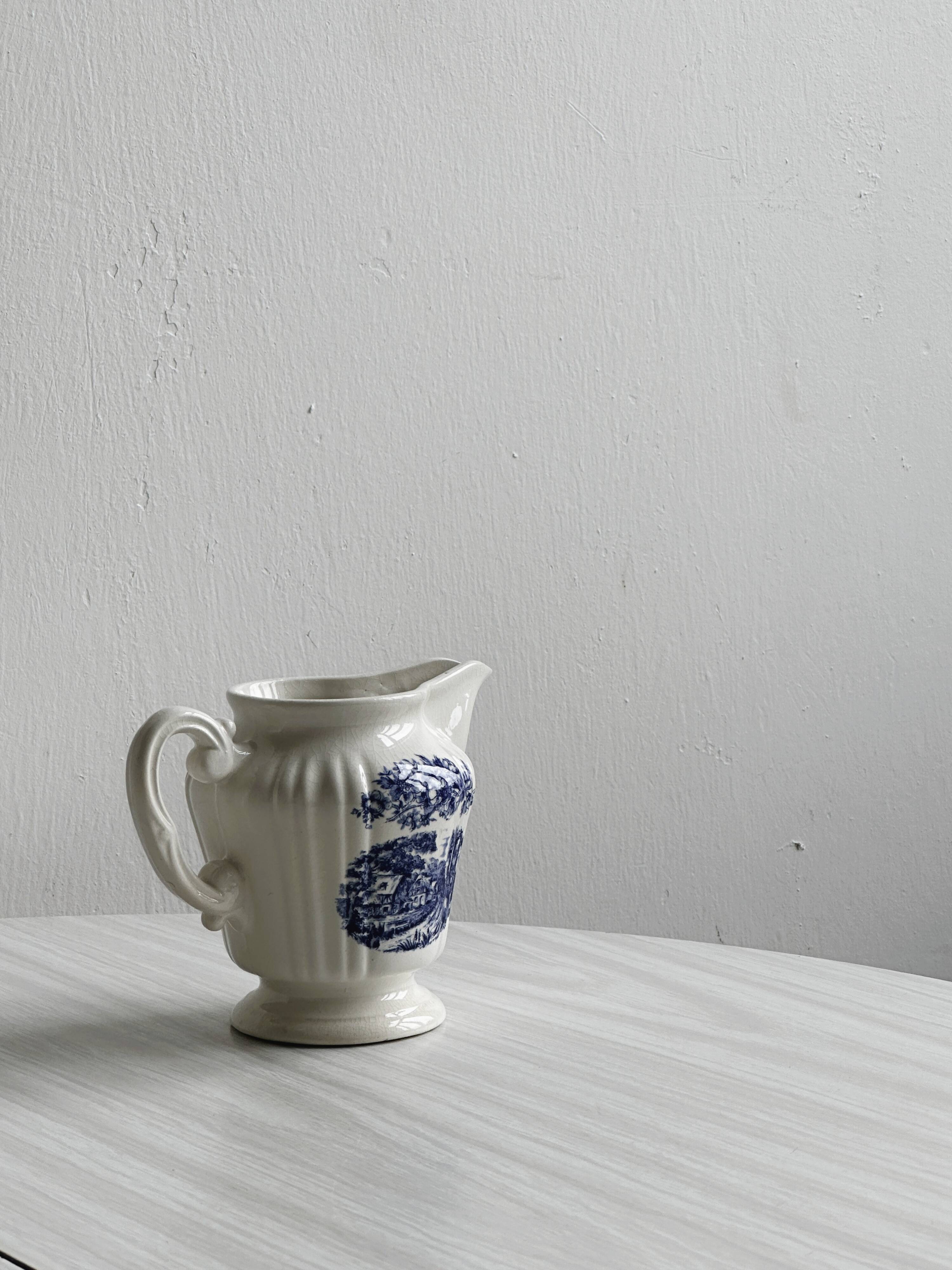 Porcelain sauce boat with blue pastoral pattern