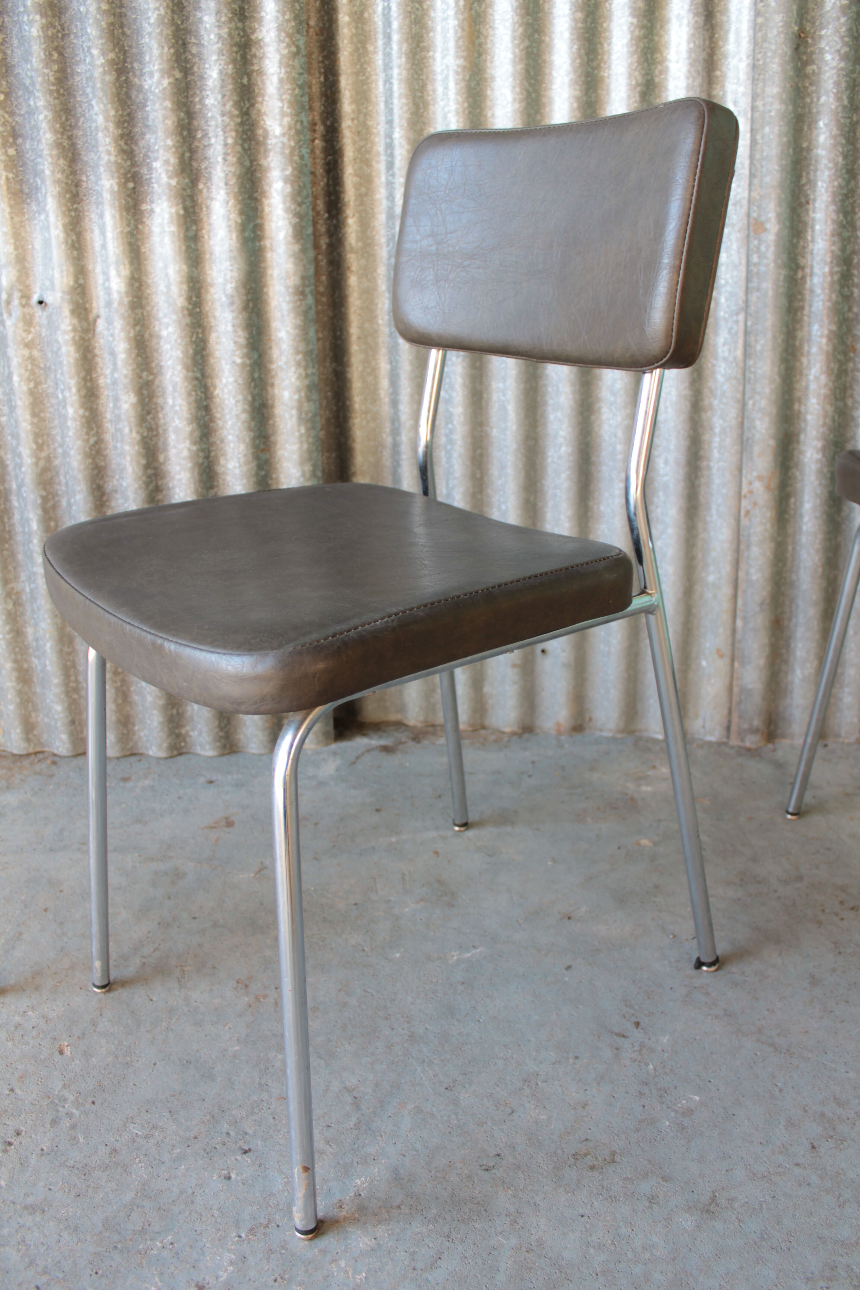 3 bronze-green faux leather chairs with chrome frames