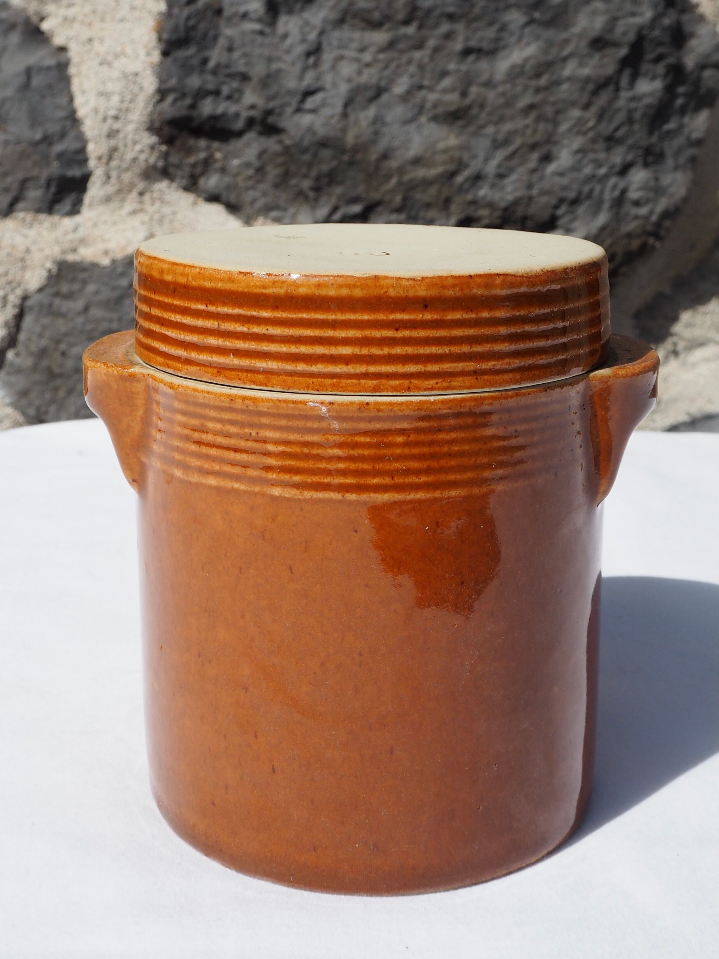 Trio of stoneware pots with lids