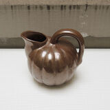 Old pitcher in glazed brown ceramic