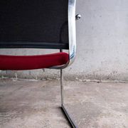 Set of 4 cantilever chairs with burgundy seat and mesh backrest.