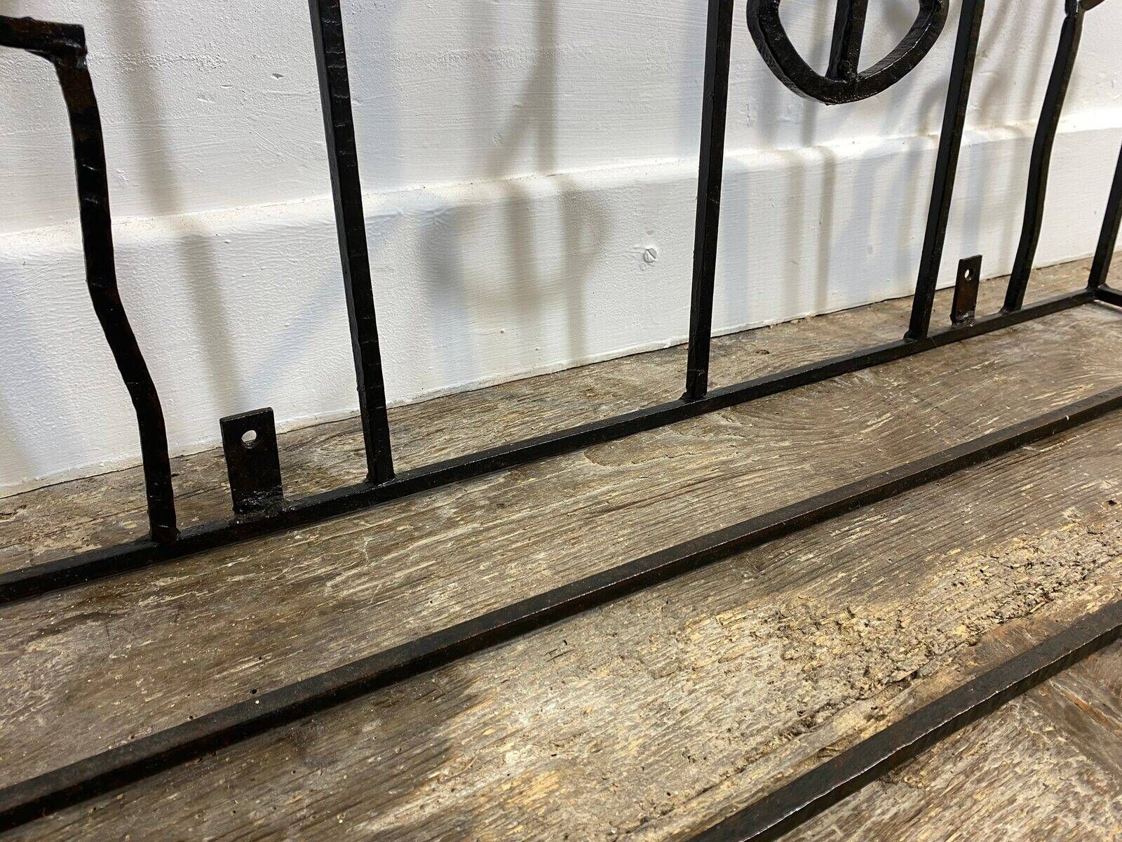 Wall-mounted coat rack in wrought iron, early 20th century