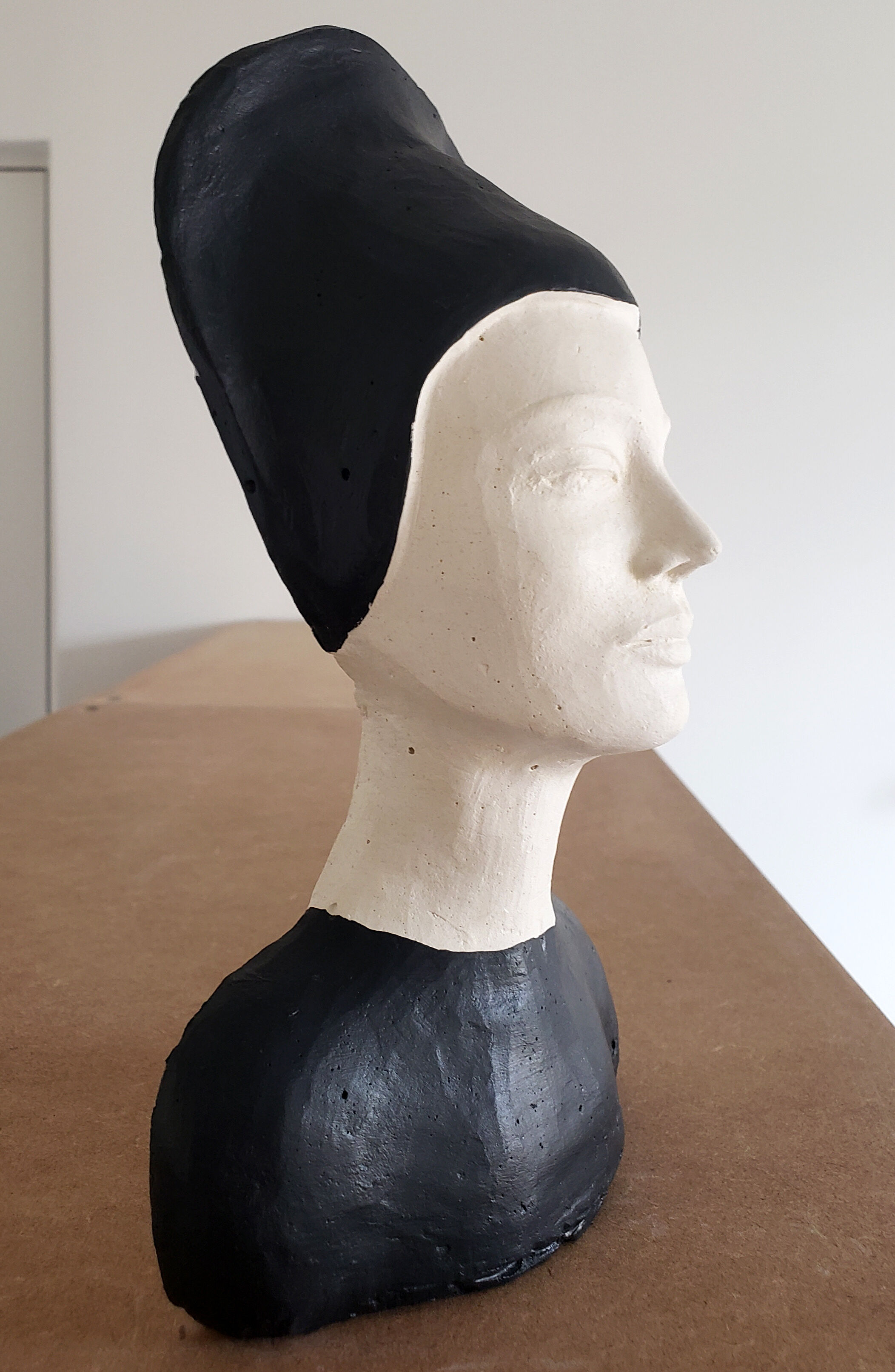 Bust of a woman in anthracite and white plaster