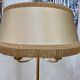 Lampadaire tripode en métal doré