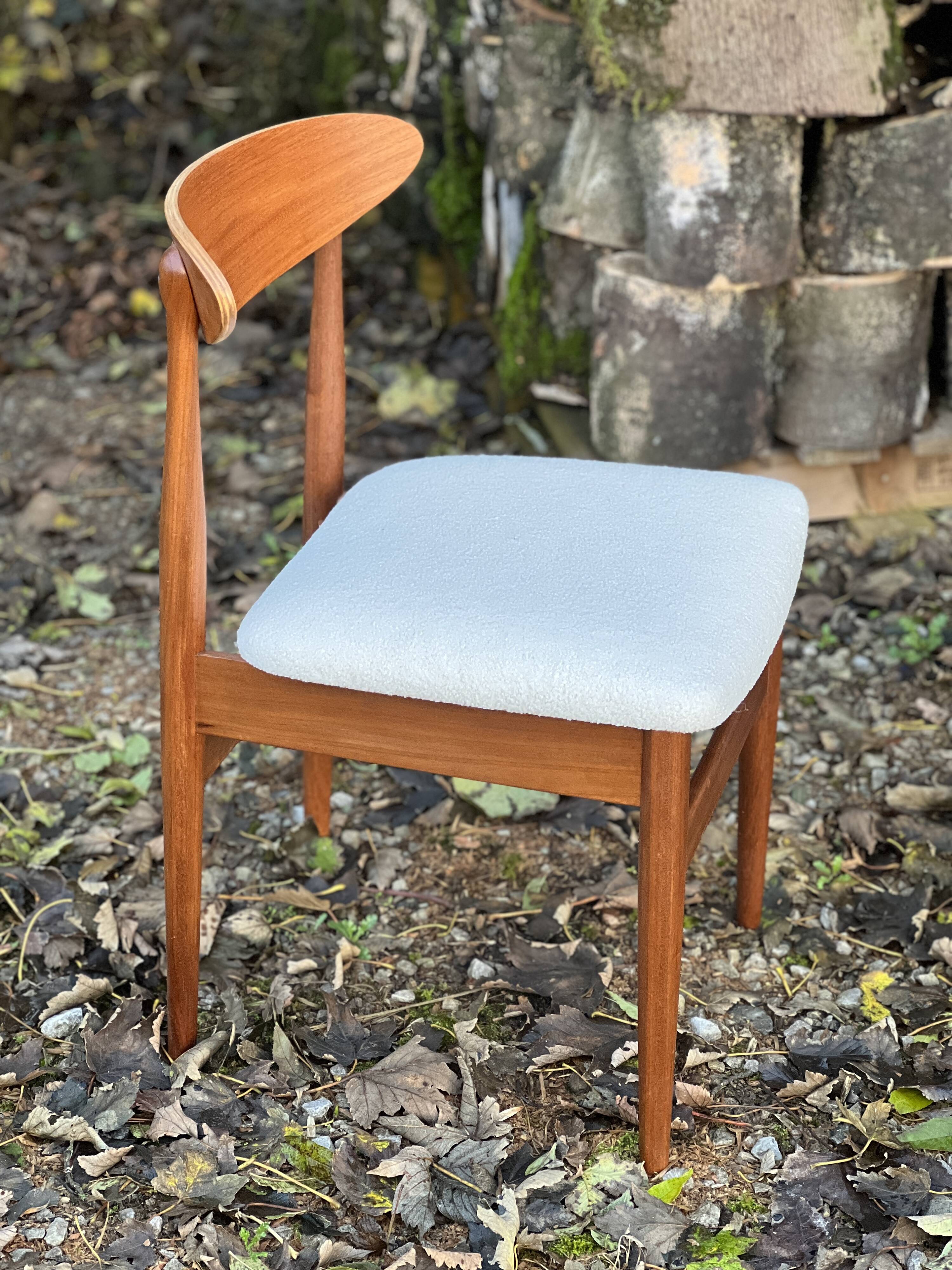 A set of GPlan chairs in teak with a white woolly fabric
