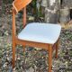 A set of GPlan chairs in teak with a white woolly fabric