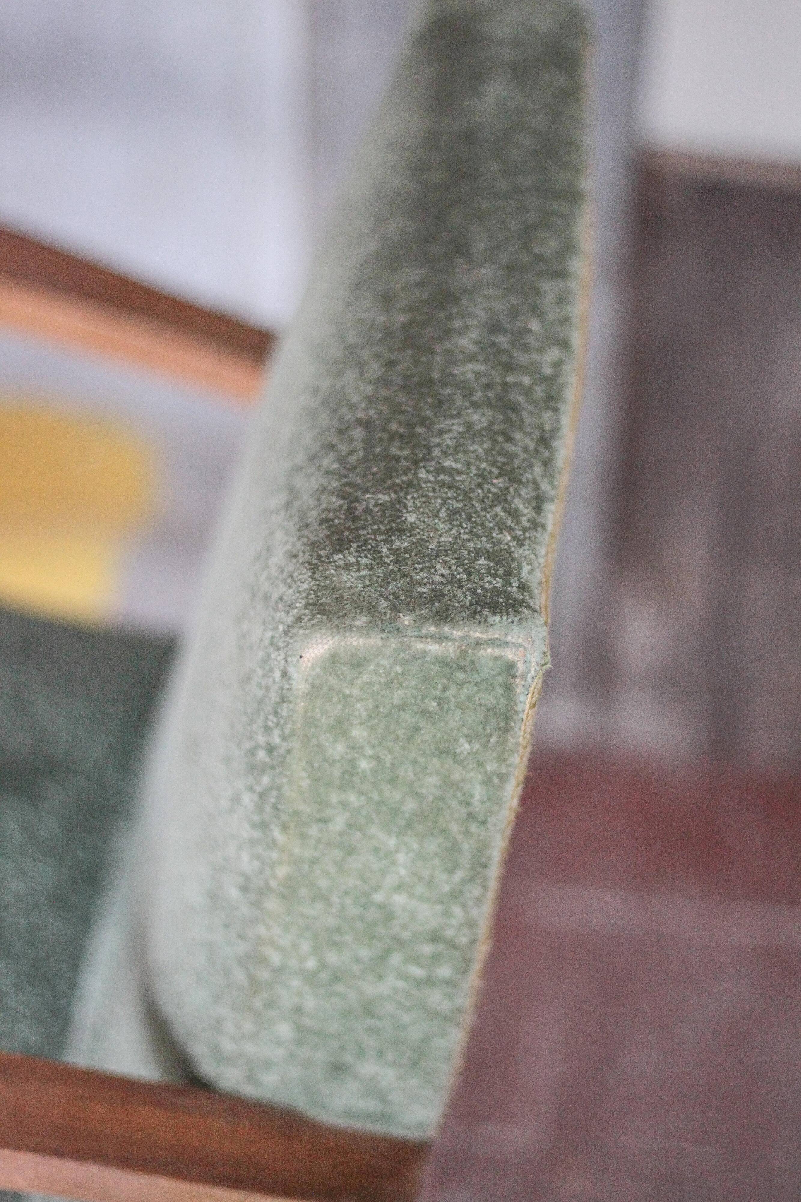 Art Deco armchair in wood and green fabric, living room armchair, interior decor.