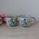 Set of two speckled stoneware mugs with small wildflower bohemian retro design.