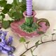 Antique slip candlestick depicting a flower