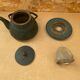 Old green cast iron Japanese teapot with flower decoration + vintage stand