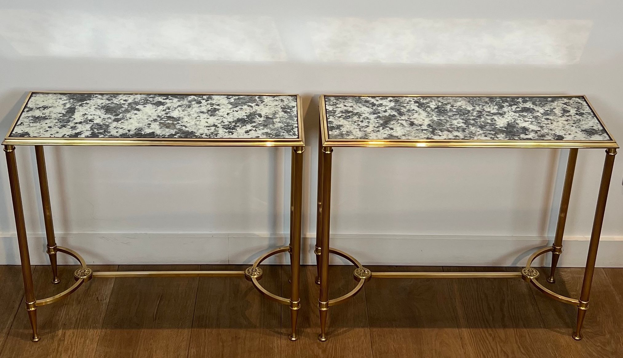 Pair of brass and antique mirror side tables from the Baguès house.