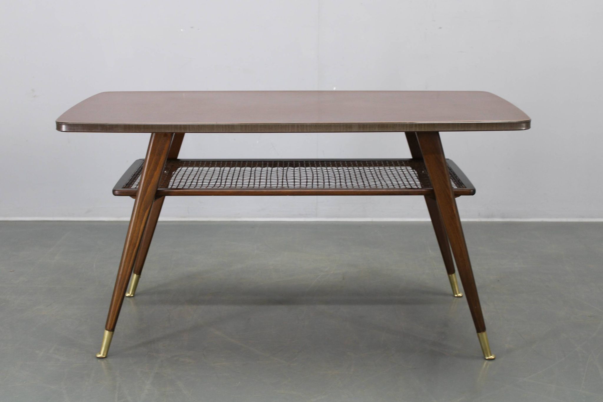 Mid-century German coffee table with rattan shelf and brass legs