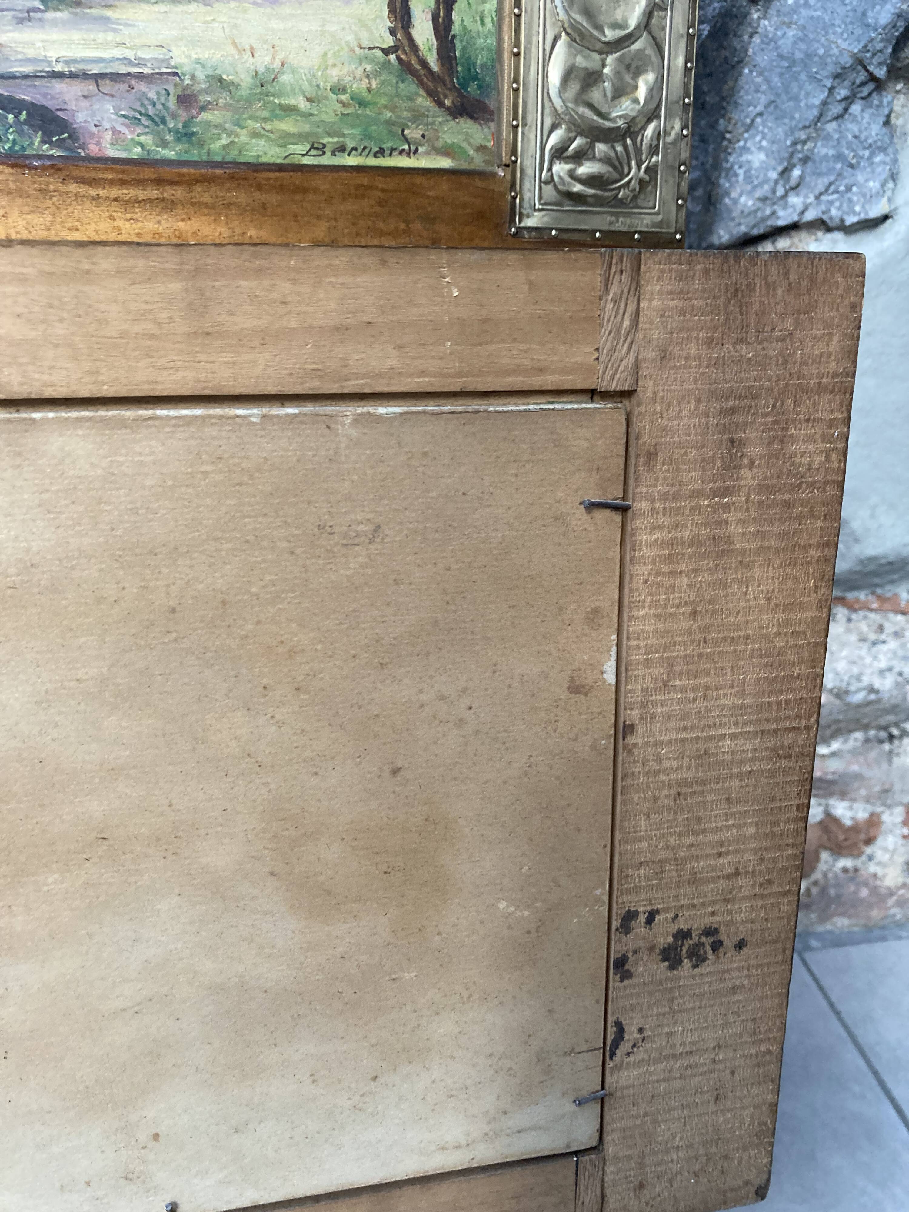 Pair of Art Deco wood and embossed metal landscape frames