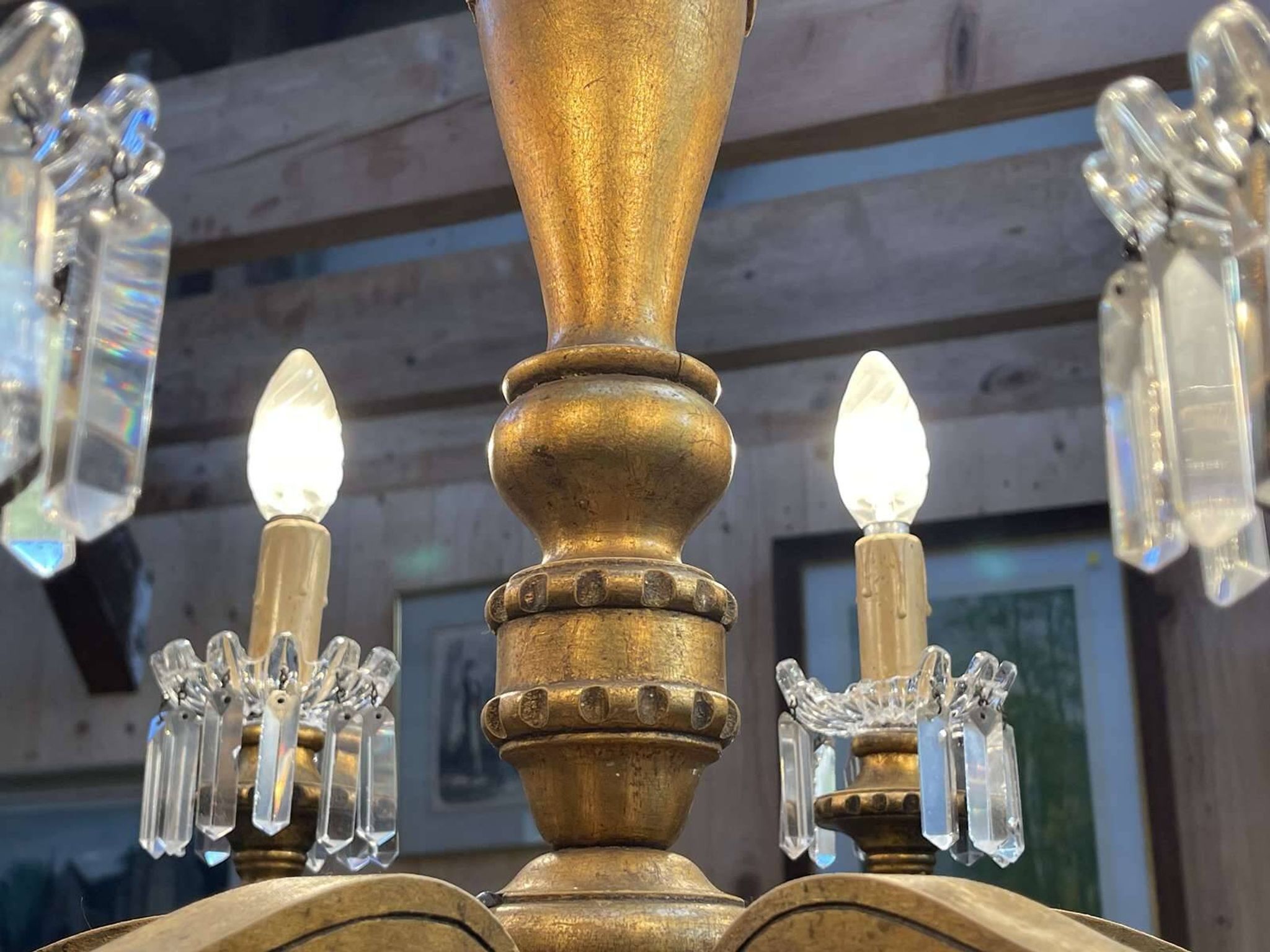 Golden wooden chandelier with crystal pendants from the 19th century.