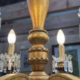 Golden wooden chandelier with crystal pendants from the 19th century.
