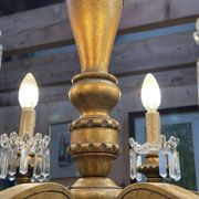Golden wooden chandelier with crystal pendants from the 19th century.