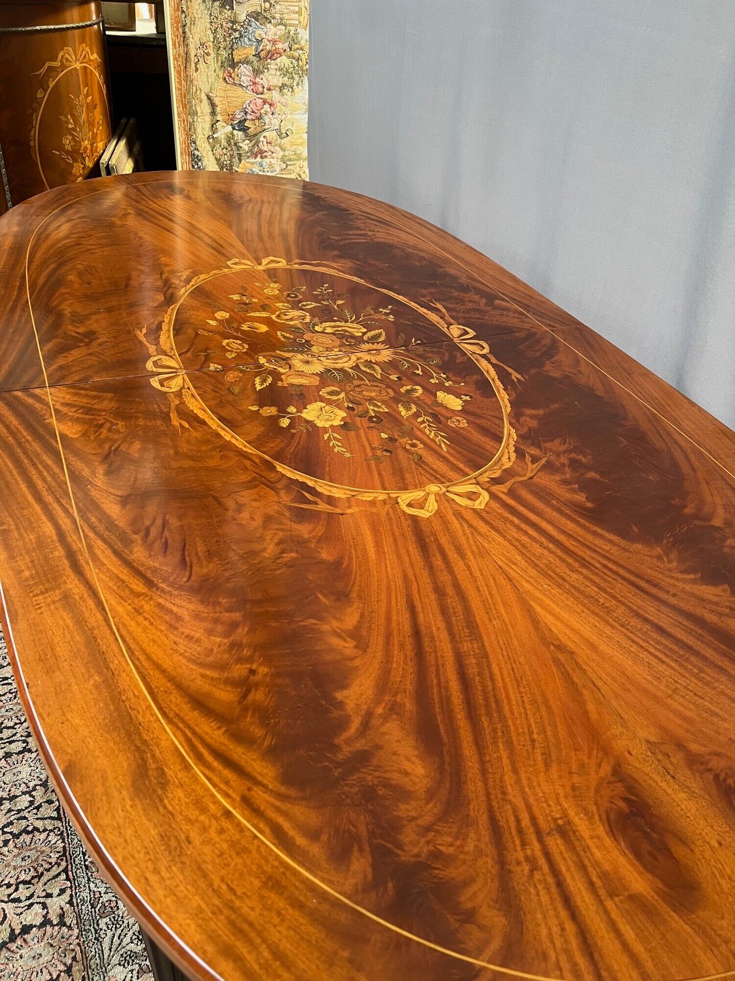 Louis XVI style oval dining table with rosewood marquetry extension mounted in bronze