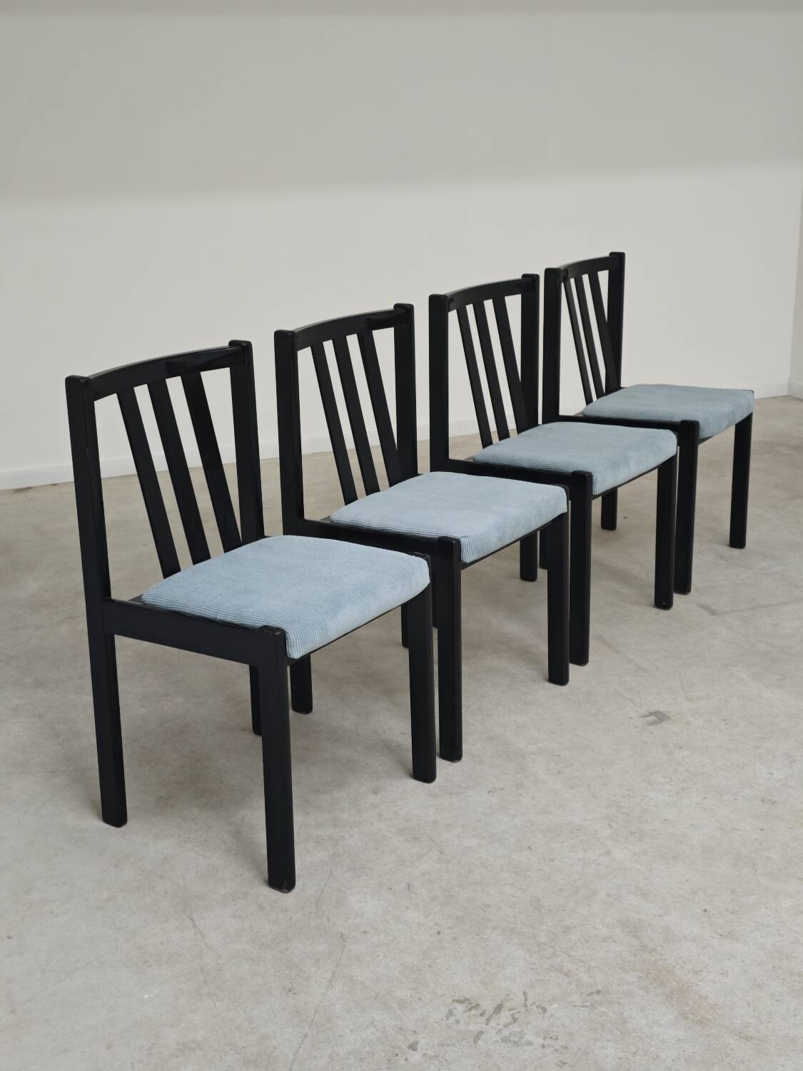 Set of 4 modernist black chairs with light blue ribbed fabric