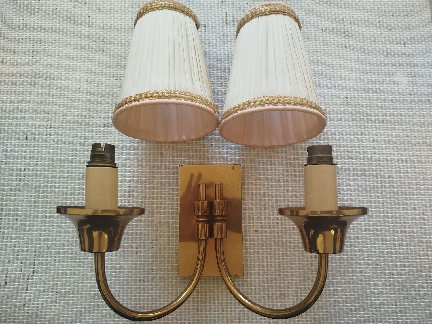 Vintage wall sconces in brass with pleated fabric shades.