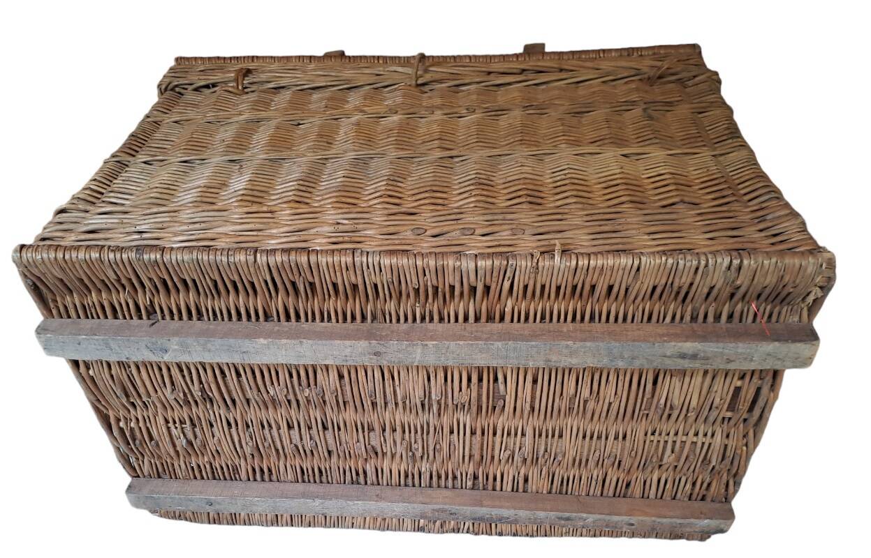 Wicker travel trunk XIX with metal clasps and handles.