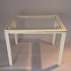 White lacquered side table by Pierre Vandel with gold brass.