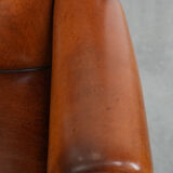 Wingback chair made of sheep leather with black piping in good condition