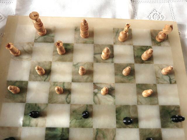 Onyx chessboard and complete wooden chess set.