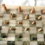 Onyx chessboard and complete wooden chess set.