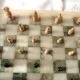 Onyx chessboard and complete wooden chess set.