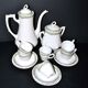Vintage Limoges coffee service with pink and green floral decoration, coffee pot, sugar bowl, and 6 cups.