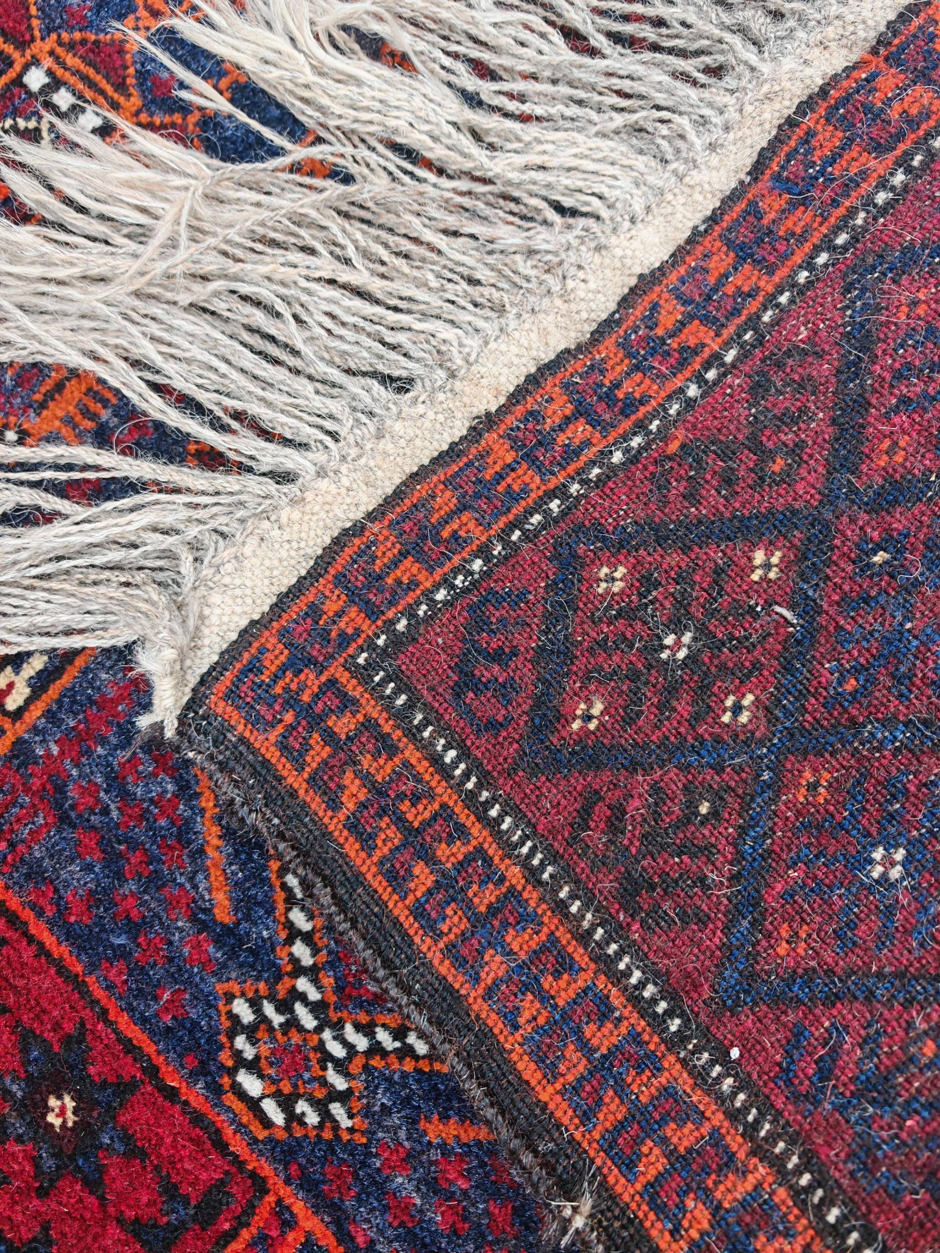 Vintage hand-knotted Persian Baluch prayer rug from the 1940s.