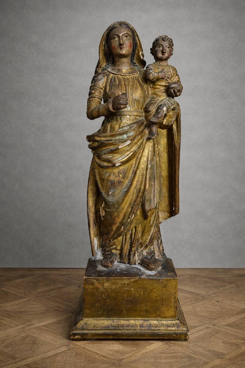 Ancient statue of the Virgin and Child in polychrome and gilded carved wood.