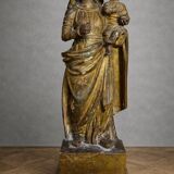 Ancient statue of the Virgin and Child in polychrome and gilded carved wood.