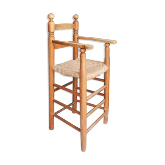 Children's high chair made of wood and straw