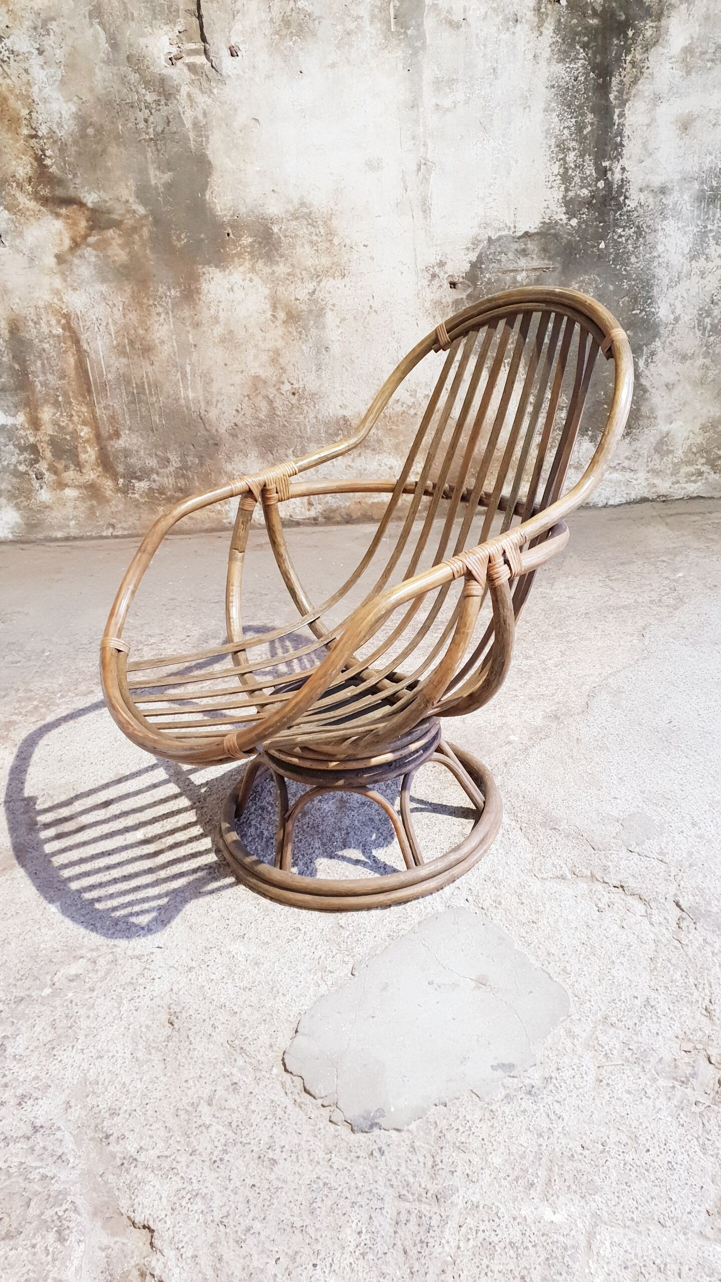 Antique swivel rattan armchair