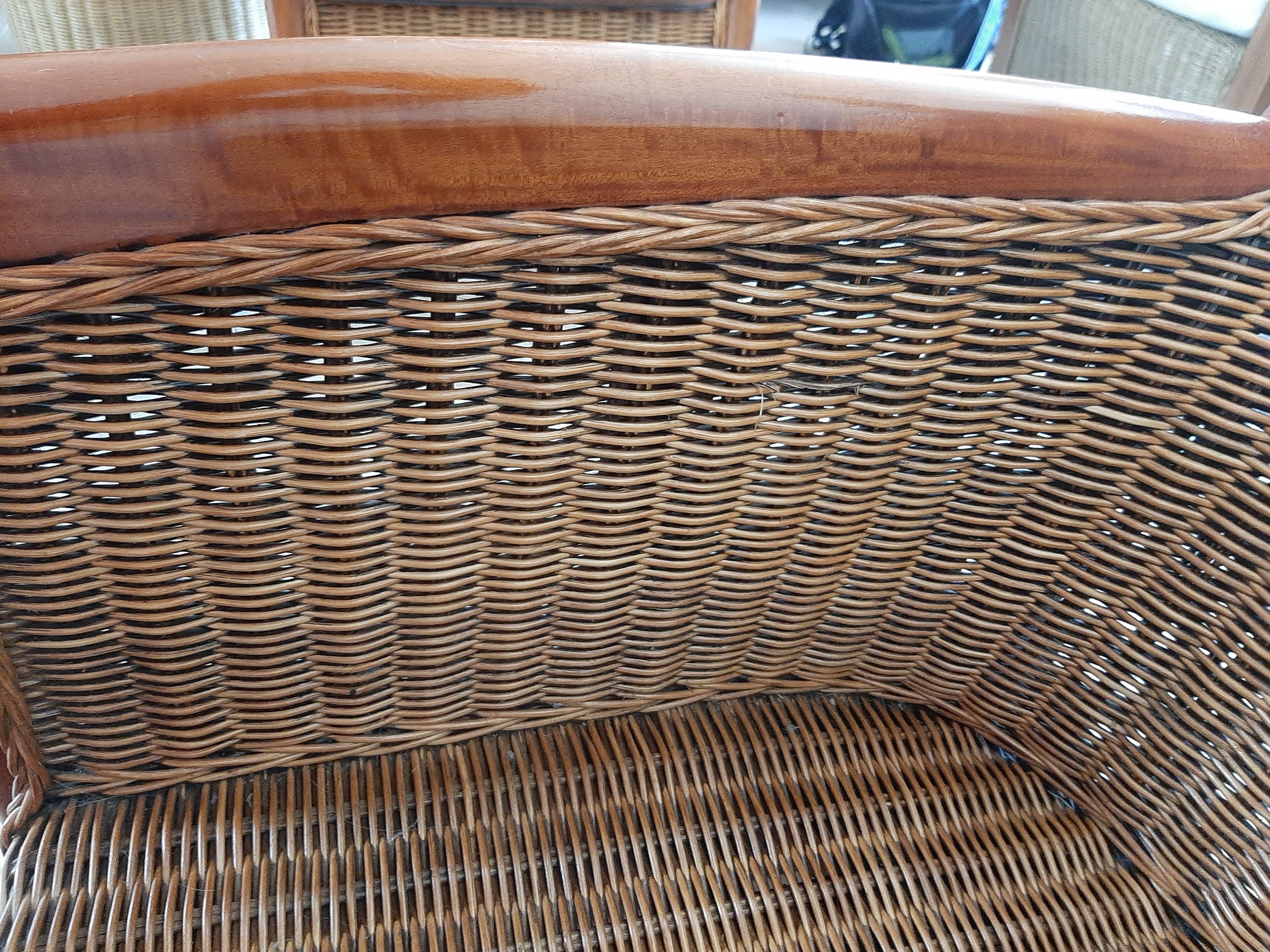 Armchair in woven rattan and exotic wood