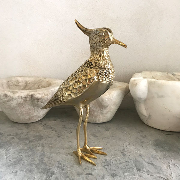 Crested bird in golden brass