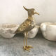 Crested bird in golden brass