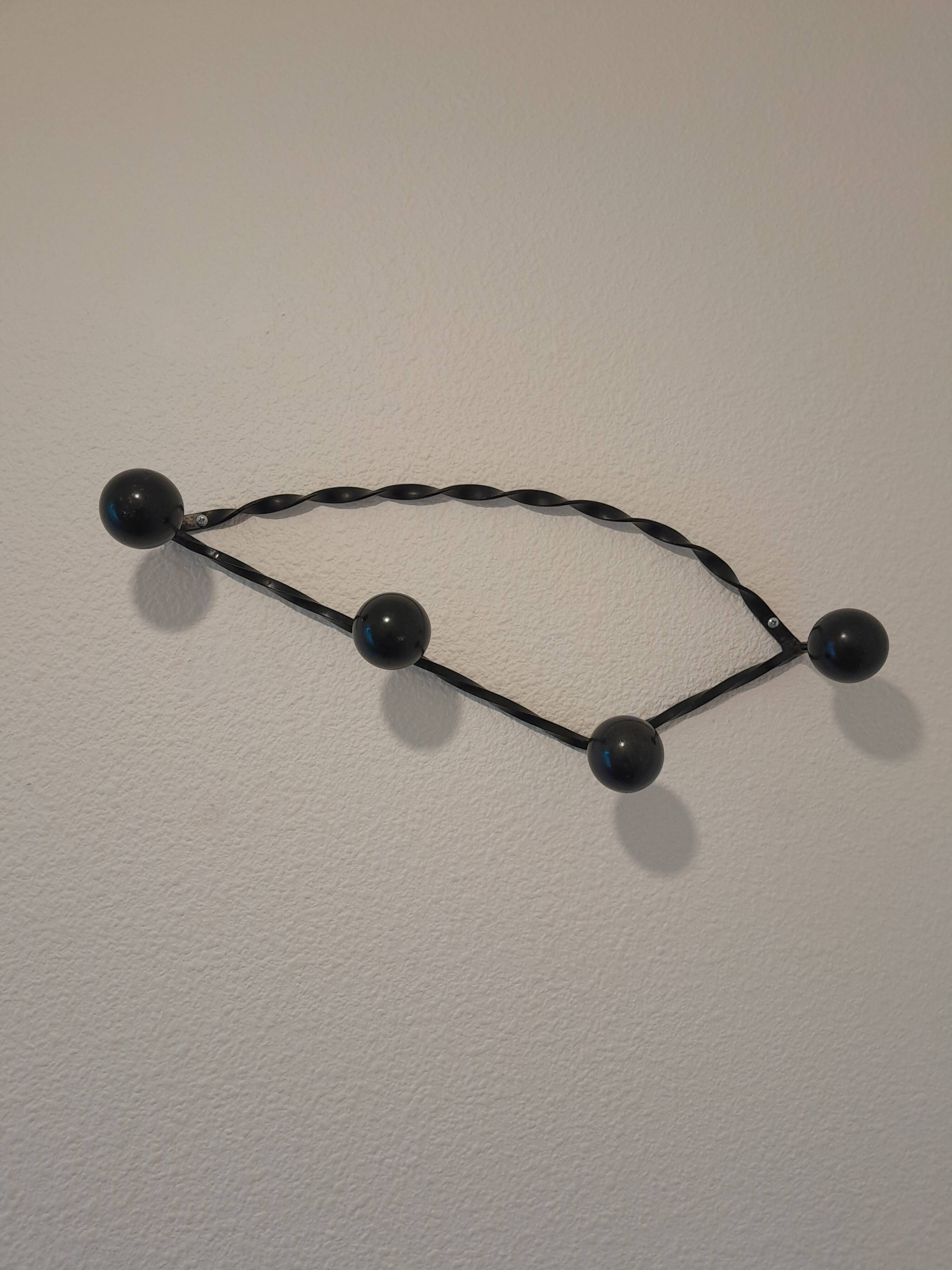 Antique design wall hook in wrought iron and painted wood.