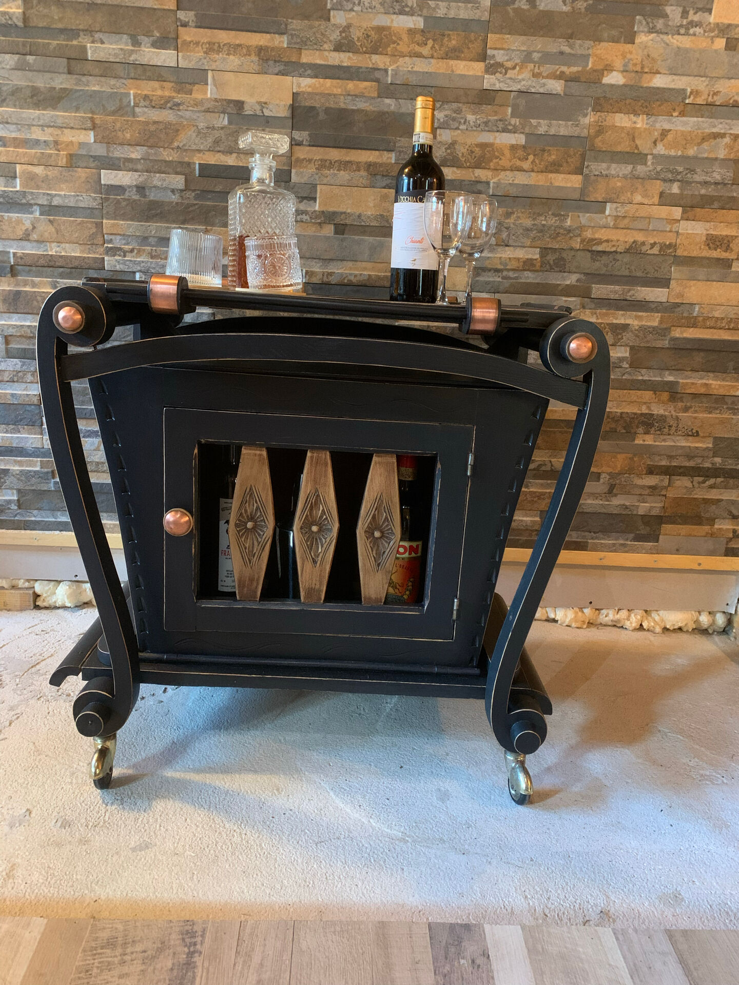 Renovated vintage bar cart in black and copper with removable serving tray.