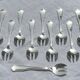 12 silver-plated oyster/dessert forks, filet pattern with contours.