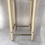 Square side table in metal and smoked glass.