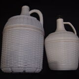 Pair of white covered demijohns