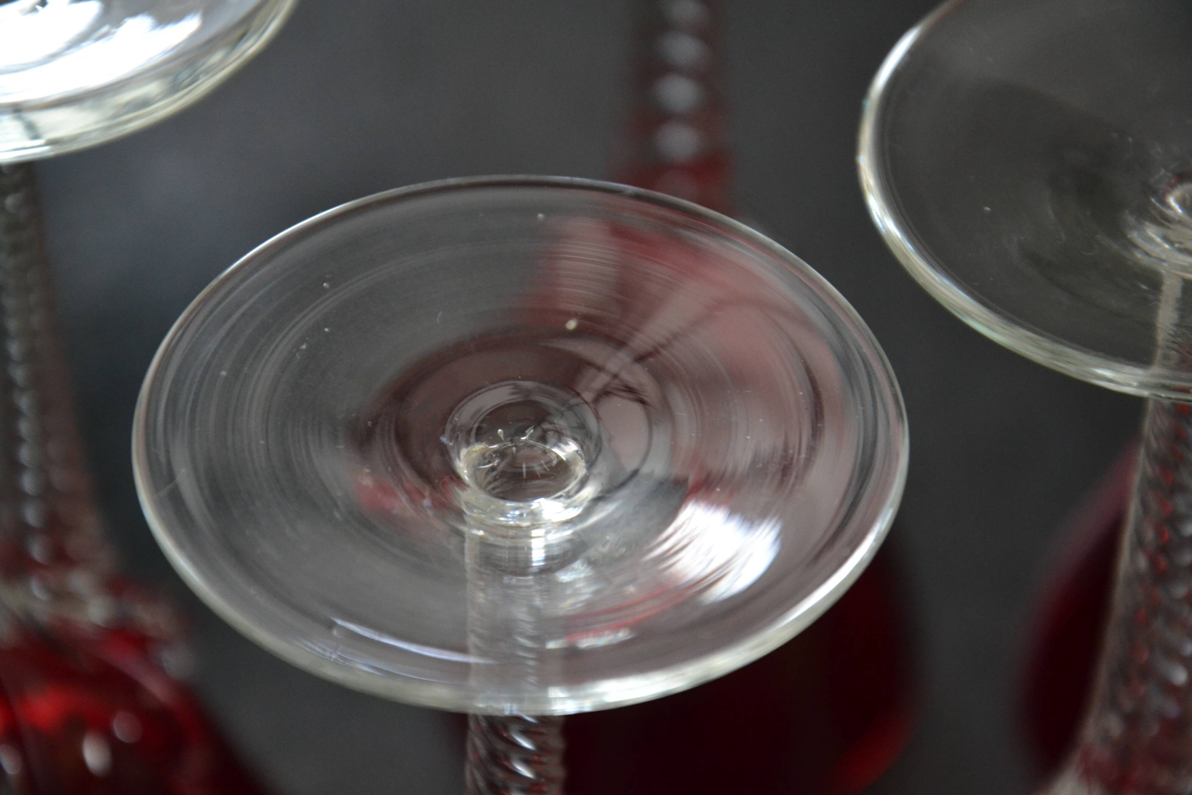 5 red crystal glasses with twisted stems