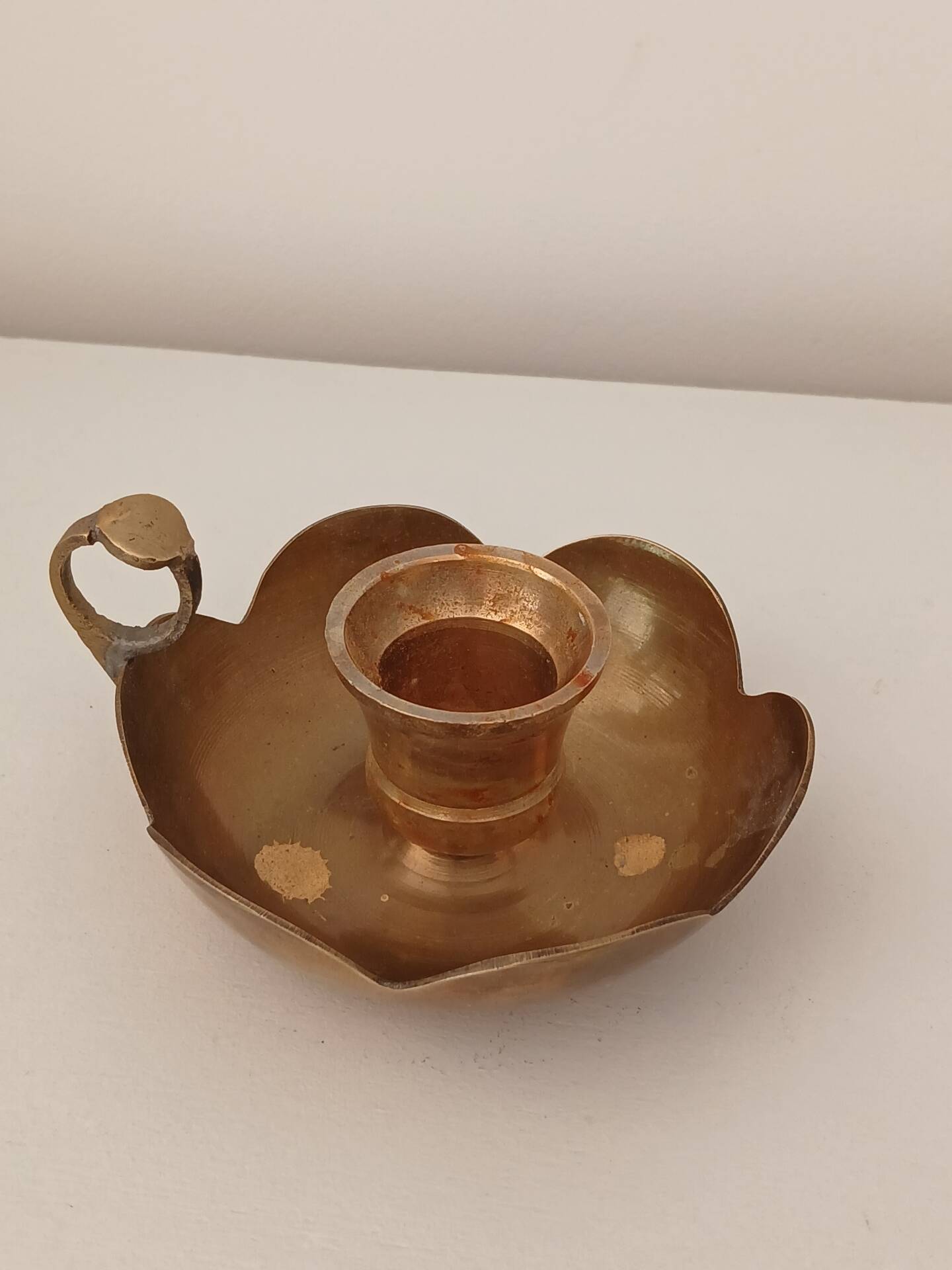 Brass candle holder in the shape of a flower.