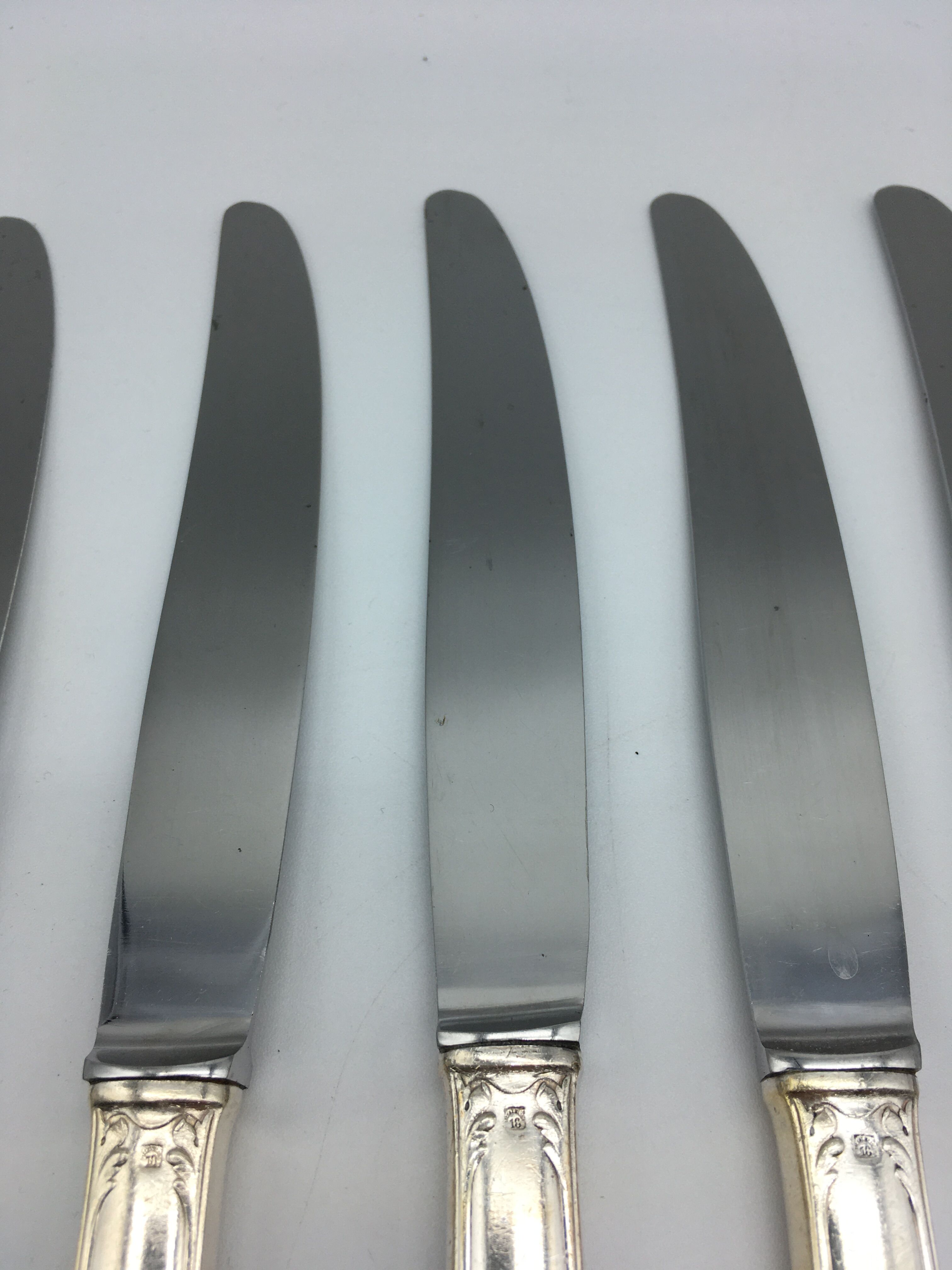 12 silver metal knives.