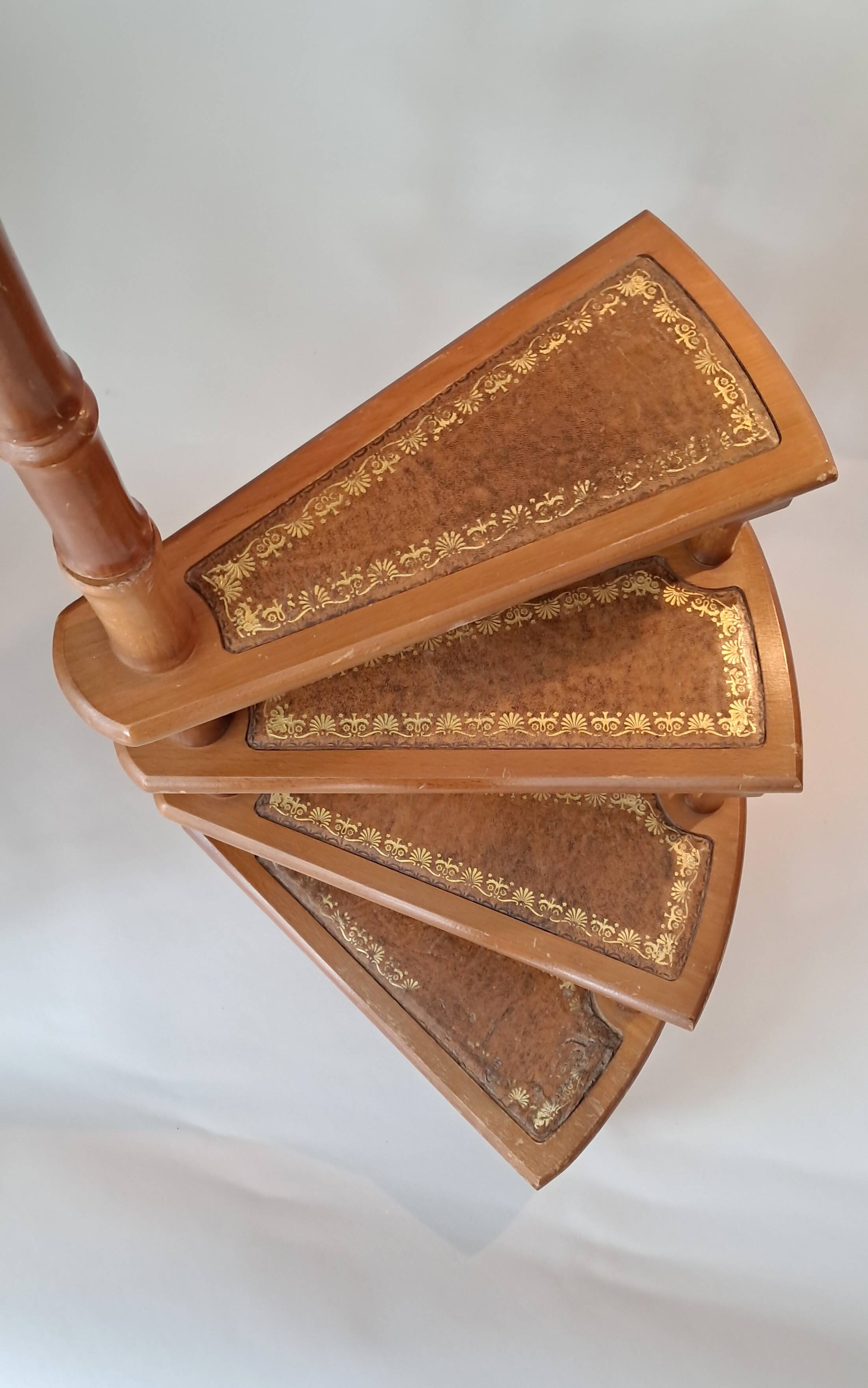 Library spiral staircase in beech and brown leather.