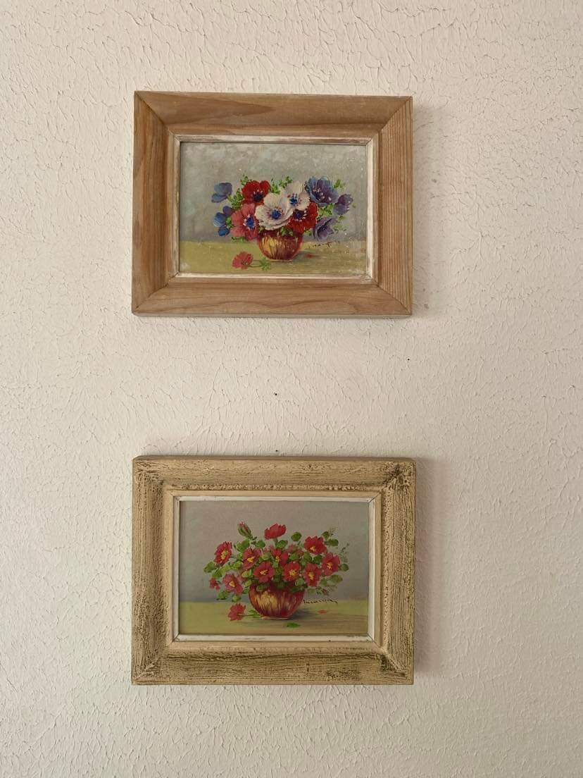 Painting red wild flowers in a vase.