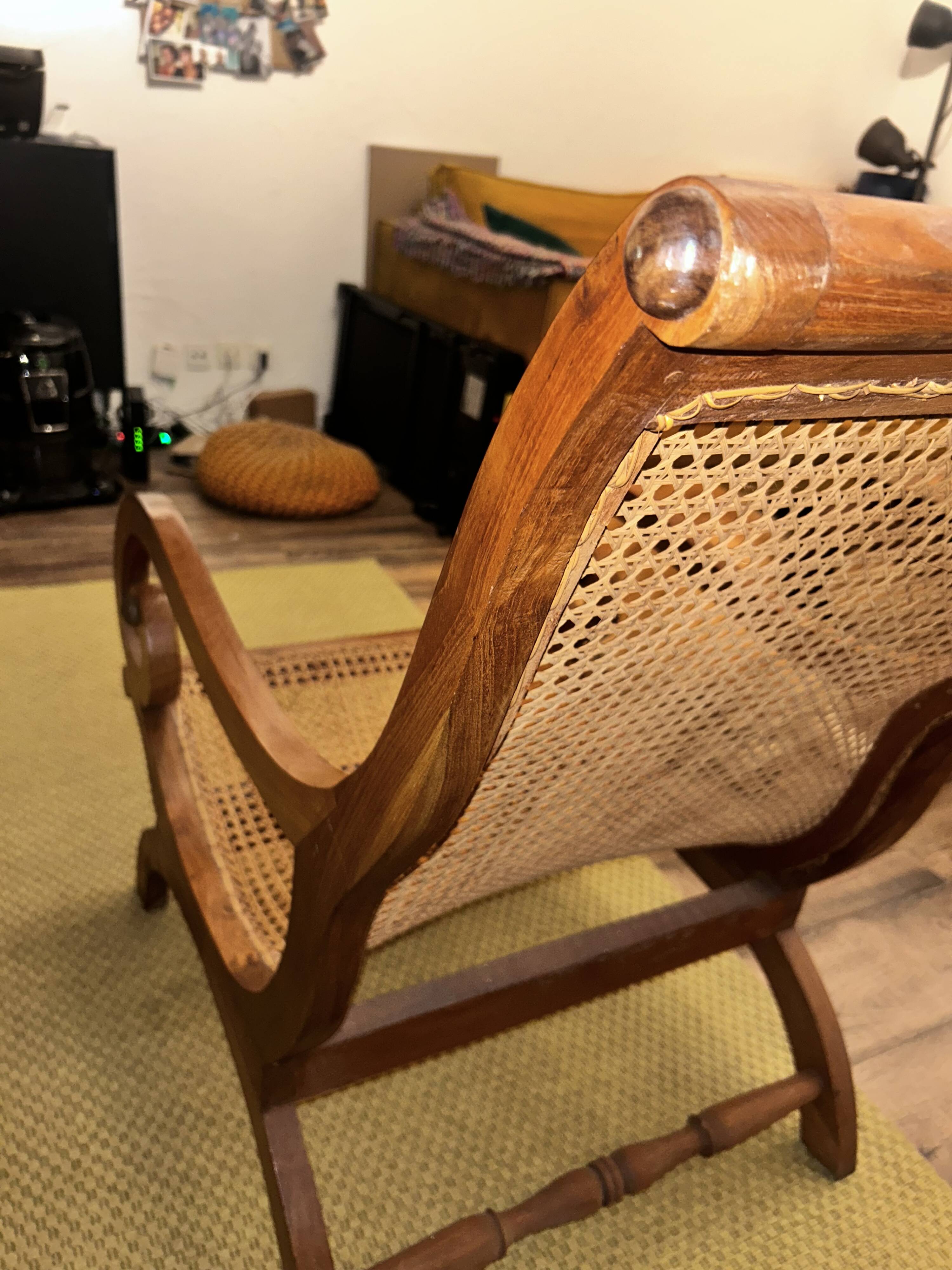 Colonial planter's armchair in solid teak, scroll armrests, caned seat.